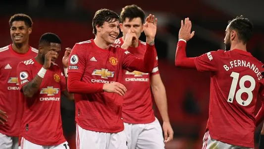 Manchester United's Swedish defender Victor Lindelof (3R) celebrates scoring his team's fourth goal with Portuguese midfielder Bruno Fernandes (R) during the English Premier League football match between Manchester United and Leeds