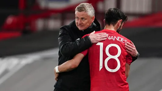 Manager Ole Gunnar Solskjaer, left, hugs with Manchester United's Bruno Fernandes during the Europa League semi final, first leg soccer match between Manchester United and Roma at Old Trafford