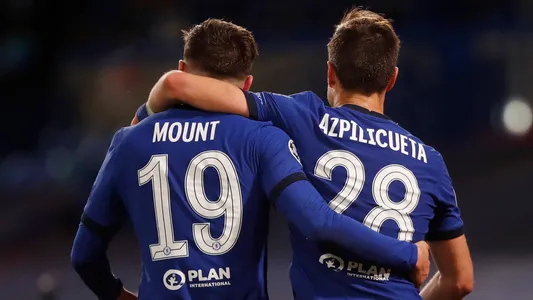 Chelsea's Mason Mount, left, celebrates with his teammate Cesar Azpilicueta after scoring his side's second goal, during the Champions League semifinal 2nd leg soccer match between Chelsea and Real Madrid at Stamford Bridge