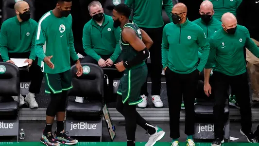Jaylen Brown limps off the court after colliding with a teammate during the second half of an NBA basketball game against the Portland Trail Blazers, Sunday, May 2, 2021