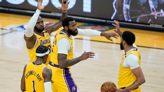 Los Angeles Lakers guard Kentavious Caldwell-Pope (1), forward LeBron James, center Andre Drummond, and forward Anthony Davis celebrate a score by Drummond against the Phoenix Suns