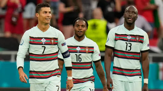 Portugal's Cristiano Ronaldo celebrates with his teammates Renato Sanches and Danilo Pereira after scoring his side's third goal during the Euro 2020 soccer championship group F match between Hungary and Portugal at the Ferenc Puskas stadium in Budapest