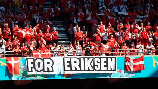 Denmark supporters display a banner for Christian Eriksen, the Danish player who collapsed during the match against Finland last Saturday