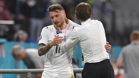 Italy's manager Roberto Mancini hugs Ciro Immobile during a Euro 2020 soccer championship quarterfinal match between Belgium and Italy at the Allianz Arena in Munich
