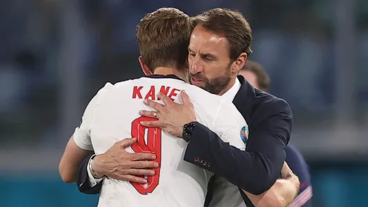 England's manager Gareth Southgate, right, greets his player Harry Kane after he was substituted during the Euro 2020 soccer championship quarterfinal soccer match between Ukraine and England at the Olympic stadium