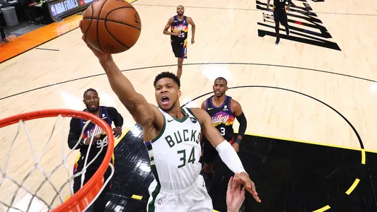 Milwaukee Bucks forward Giannis Antetokounmpo (34) moves in for a basket ahead of Phoenix Suns forward Jae Crowder (99) and guard Chris Paul (3) during Game 2 of basketball's NBA Finals