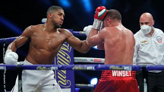 Anthony Joshua throws a punch at challenger Kubrat Pulev during their Heavyweight title fight at Wembley Arena in London Saturday, Dec. 12, 2020