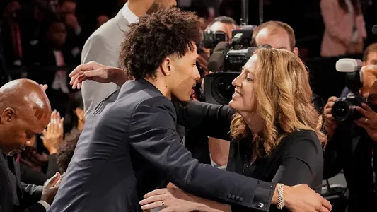 Cade Cunningham, left, hugs family and friends after being selected as the number one draft pick overall by the Detroit Pistons during the NBA basketball draft