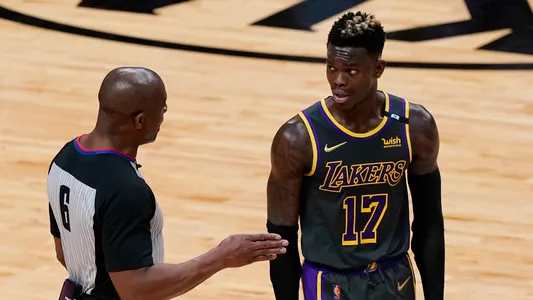 Los Angeles Lakers guard Dennis Schroder (17) listens to NBA referee Tony Brown (6) during the second half of an NBA basketball game against the Miami Heat