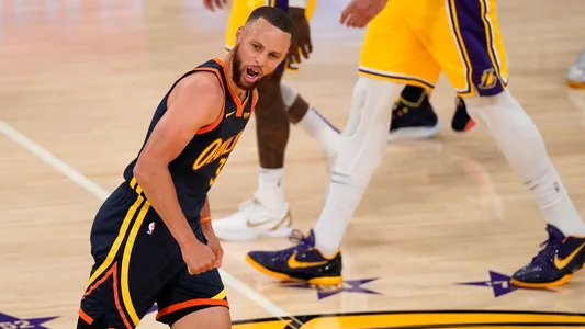 Stephen Curry celebrates after hitting a three-point shot at the end of the first half of an NBA basketball Western Conference Play-In game against the Los Angeles Lakers Wednesday, May 19, 2021, in Los Angeles