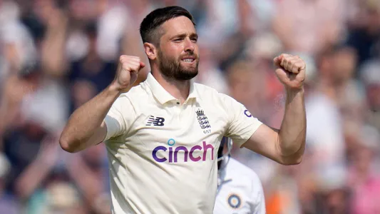 England's Chris Woakes celebrates taking the wicket of India's Ajinkya Rahane on day four of the fourth Test match at The Oval cricket ground in London