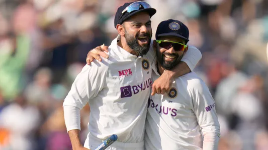 India's Virat Kohli, left, and India's KL Rahul smile as they leave the pitch after India beat England by 157 runs on day five of the fourth Test match at The Oval cricket ground in London