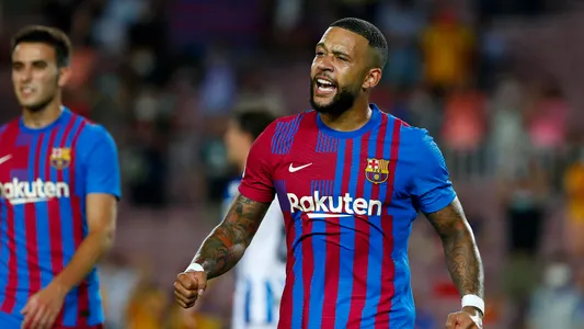 Barcelona's Memphis Depay celebrates after teammate Martin Braithwaite scored their side's third goal during a Spanish La Liga soccer match between Barcelona and Real Sociedad