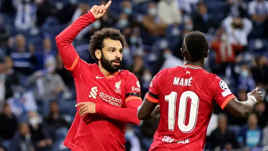 Liverpool's Mohamed Salah celebrates with Sadio Mane, right, after scoring the opening goal during the Champions League group B soccer match between FC Porto and Liverpool at the Dragao stadium in Porto