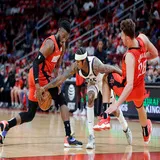 Houston Rockets forward David Nwaba, left, forces a turnover as Utah Jazz guard Jordan Clarkson, middle, tries to keep control and Rockets center Alperen Sengun (28) falls back during the second half of an NBA basketball game.