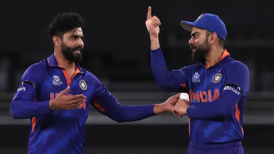 India's Ravindra Jadeja interacts with captain Virat Kohli before bowling his next delivery during the Cricket Twenty20 World Cup match between India and Namibia in Dubai