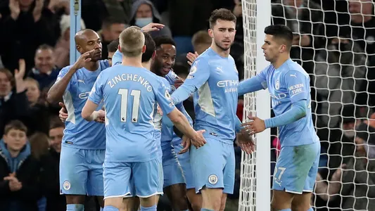 Manchester City's Raheem Sterling, center, celebrates after scoring his side's sixth goal during the English Premier League soccer match between Manchester City and Leicester City at Etihad stadium