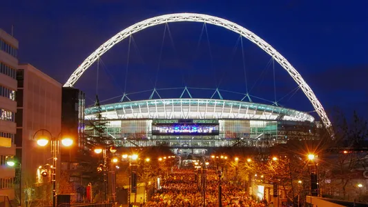The illuminated arch of Wembley Stadium in London, UK — Photo by ratherton