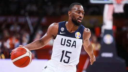 Kemba Walker, left, runs the ball for USA at the 2019 FIBA Basketball World Cup — Photo by ChinaImages