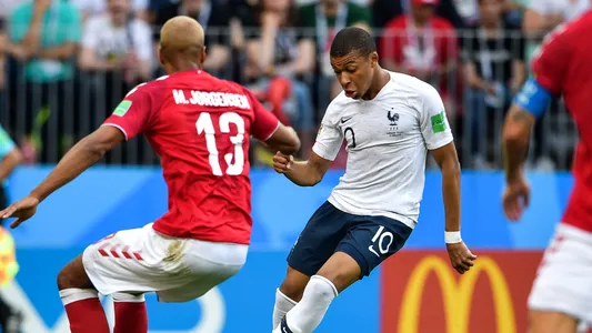 Kylian Mbappe of France, right, challenges Mathias Jorgensen of Denmark in their Group C match during the 2018 FIFA World Cup in Moscow, Russia, 26 June 2018 — Photo by ChinaImages
