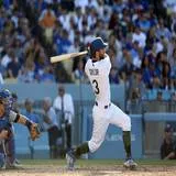 A Los Angeles Dodgers player hits a two run home run against the Chicago Cubs