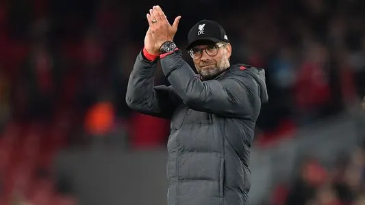 Jurgen Klopp applauds supporters on the pitch after the UEFA Champions league Group E football match between Liverpool and Salzburg at Anfield