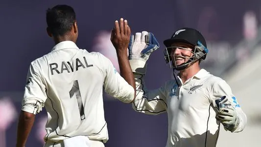 New Zealand's Jeet Raval (L) is congratulated by teammate BJ Watling (R) after he bowled out Australia's Pat Cummins on day two of the first Test cricket match between Australia and New Zealand at the Perth Stadium