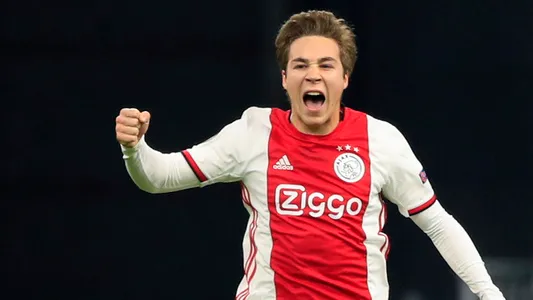 Ajax's Carel Eiting celebrates soaring his side's second goal during a round of 32, second leg, Europa League soccer match between Ajax and Getafe
