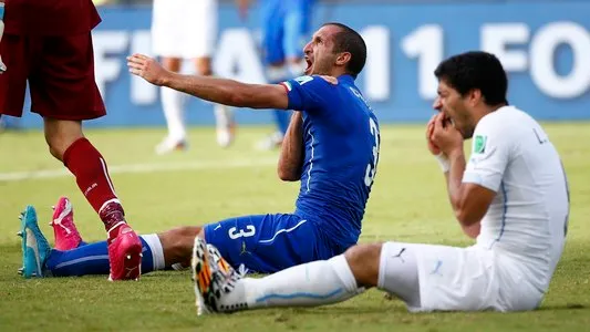 Uruguay's Luis Suarez holds his teeth after biting Italy's Giorgio Chiellini's shoulder during the group D World Cup soccer match between Italy and Uruguay in Natal