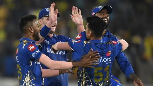 Mumbai Indians cricketers celebrate taking the wicket of Chennai Super Kings captain Mahendra Singh Dhoni during the 2019 Indian Premier League (IPL) Twenty20 final cricket match between Mumbai Indians and Chennai Super Kings
