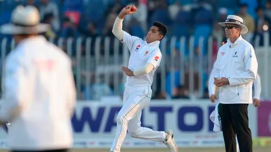 Pakistan's Naseem Shah (C) delivers the ball during the third day of the first cricket Test match between Pakistan and Bangladesh at the Rawalpindi Cricket Stadium