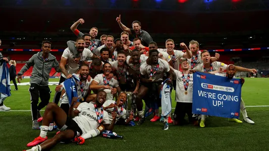Fulham players celebrate winning the EFL playoff final trophy as they won the final 2-1 and are promoted to the Premier League; Wembley Stadium