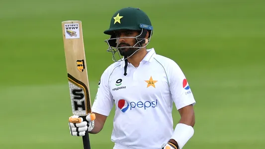 Pakistan's Babar Azam reaches 50 runs during the first day of the first Test cricket match between England and Pakistan at Old Trafford