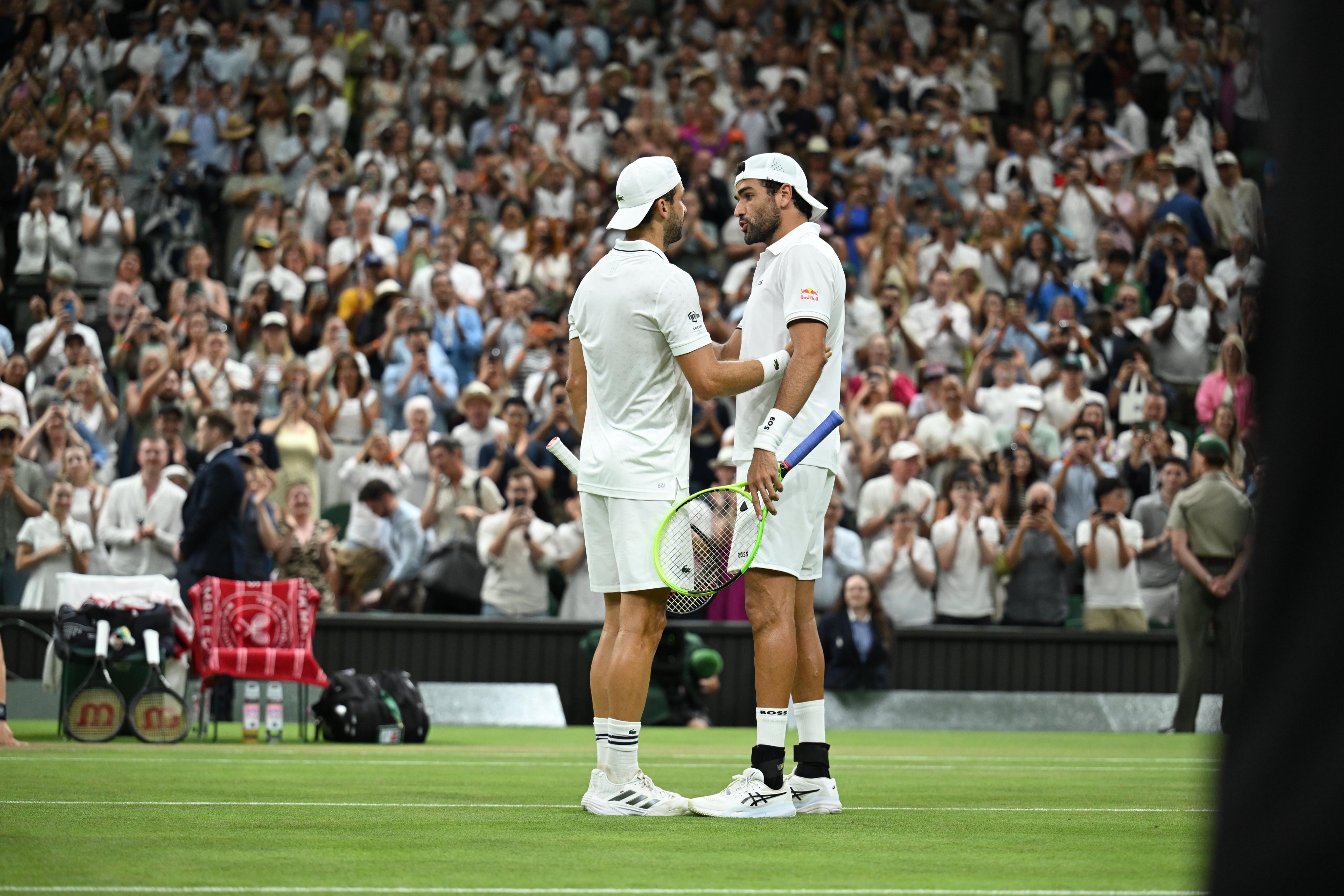 Grigor Dimitrov and Matteo Berrettini on Center Court at Wimbledon. London, UK. July 4, 2026. Photo credit: The Championships.